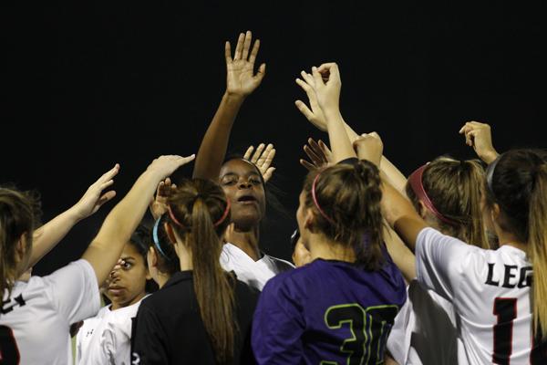 Peyton McGee, 12, leads the varsity girls soccer team in a huddle after a win.