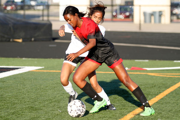 Dribbling toward the goal, Peyton McGee, 12, pushes off a defender at the first round playoff game. 