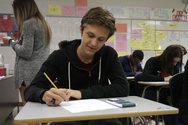Antoine Briard, 11, works on a paper in class. Briard is a foreign exchange student from Paris, France. 