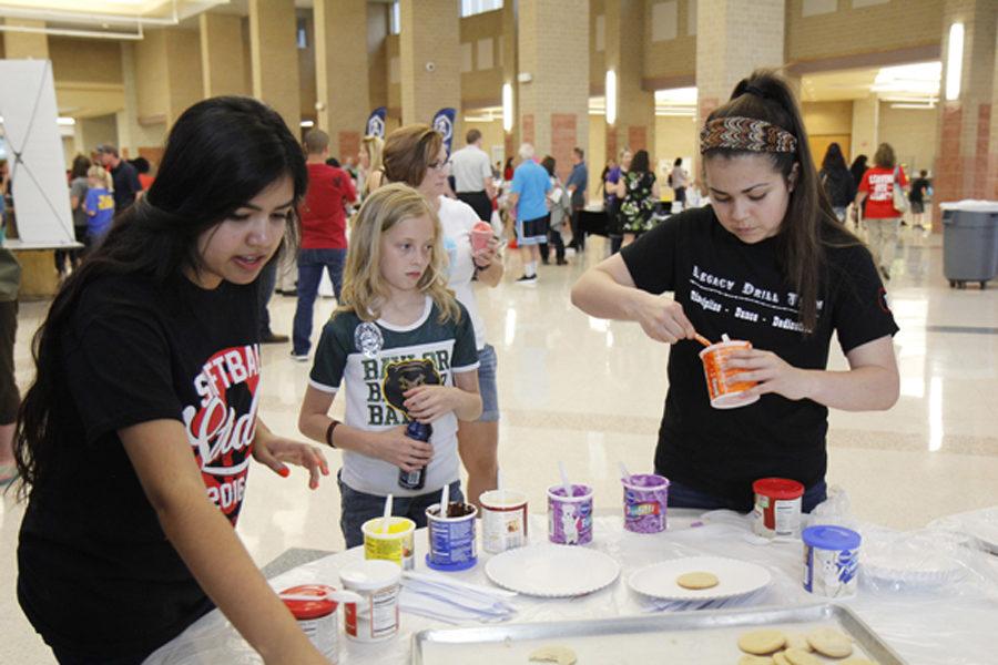 Legacy NHS students at the 2016 Westside Picnic decorate cookies with a future Legacy Bronco. This years Westside Picnic will take place on April 18.