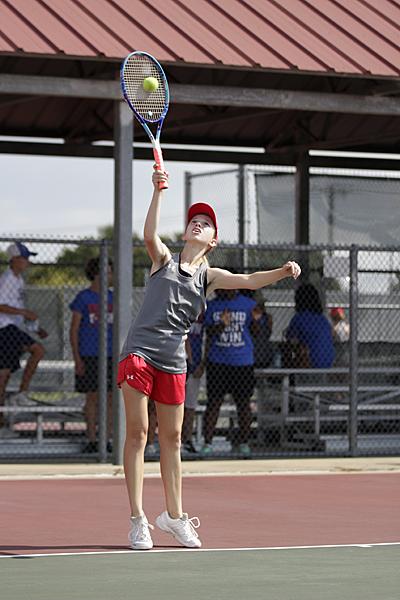 Megan Novak, 10, serves the ball to the 3rd girls doubles team from Midlothian on Aug. 29. 
Varsity tennis will play again Sep. 12 at Timberview. (Ellie Brutsche photo) 
