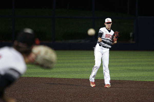 Nathan Rooney, 10, throws to the first baseman. 
