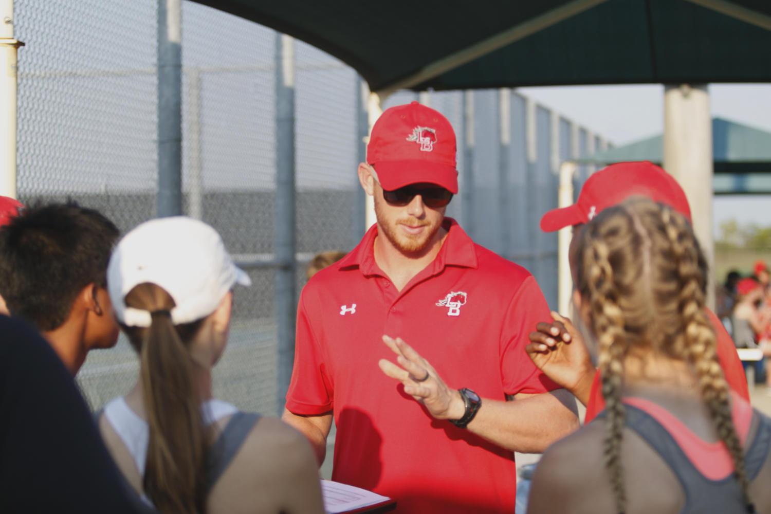 Coach Dozier talks to the JV tennis team about how they all performed. JV will play Timberview Sept. 14 at Legacy High School. (Dalton Mix photo)
