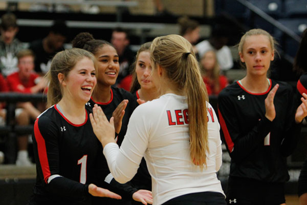 Senior Katelyn Allen cheers on her teammate before the start of the Varsity Volleyball match against Richland. 