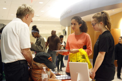 Sophomores Isabella Estes and Brinley Koenig speak with a college representative at College and Career night. The event was held at The Center to give students a chance to speak with admissions counselors from schools across Texas.