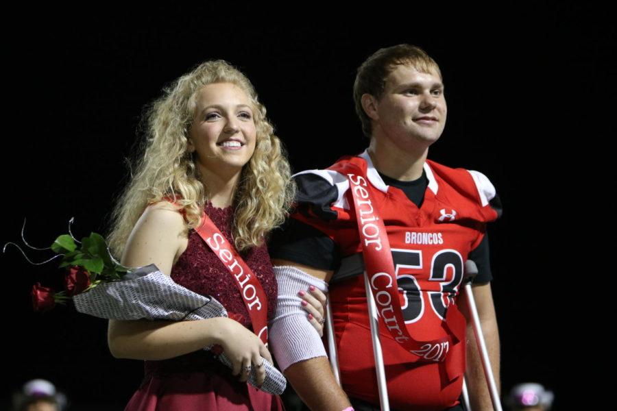 Sadie Johnson, 12, and Toby Griffin, 12, stand on the field as senior king and queen nominees. The nominees were voted for during the week before the game by their peers. (Zane Hudson photo)