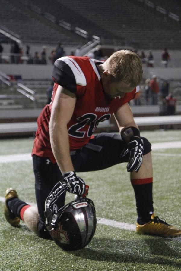Justin OShields, 12, prays after Legacy defeats Waxahachie. The game was Legacys homecoming game. (Tori Greene photo)
