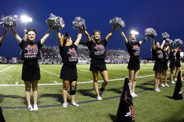 Cheer performs during kick off to hype up the crowd at the game against Midlothian.