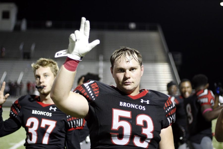 Senior Toby Griffin stands for the School Song at the ending of the game against Mansfield Timberview, the last game he played before finding out he could no longer participate in football.