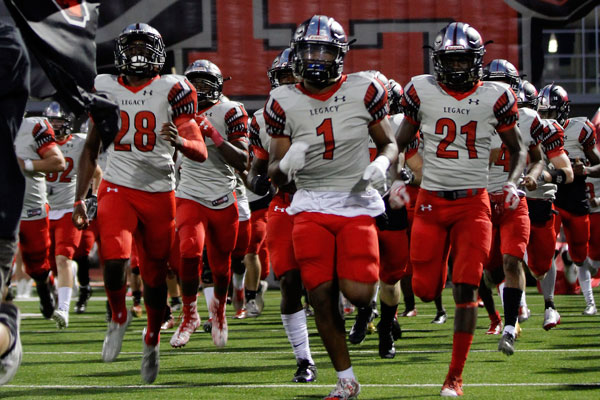 Football players run out of the tunnel before the game against Lancaster. 