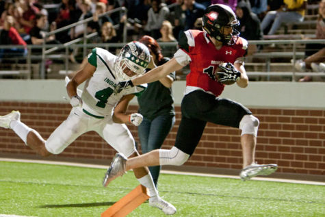 Junior Nathan Rooney scored a touchdown during the varsity football game against Waxahachie on Oct. 20. The Broncos won the game 39-34. Rooney has scored four touchdowns this season. 