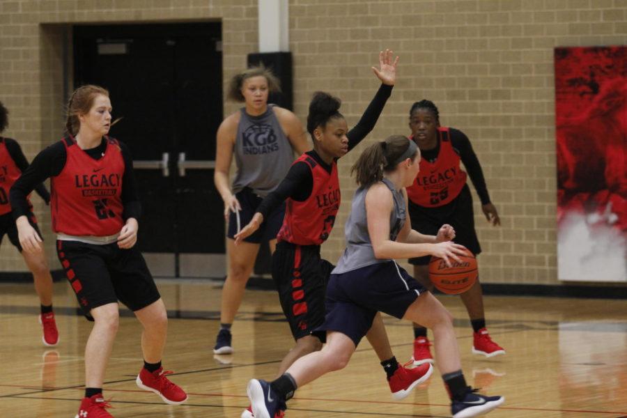 The Varsity Girls Basketball team plays a game in Legacys Varsity gym.