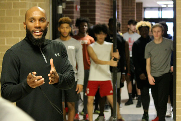 Coach Trey Bates leads practice the boys track indoors due to inclement weather. 