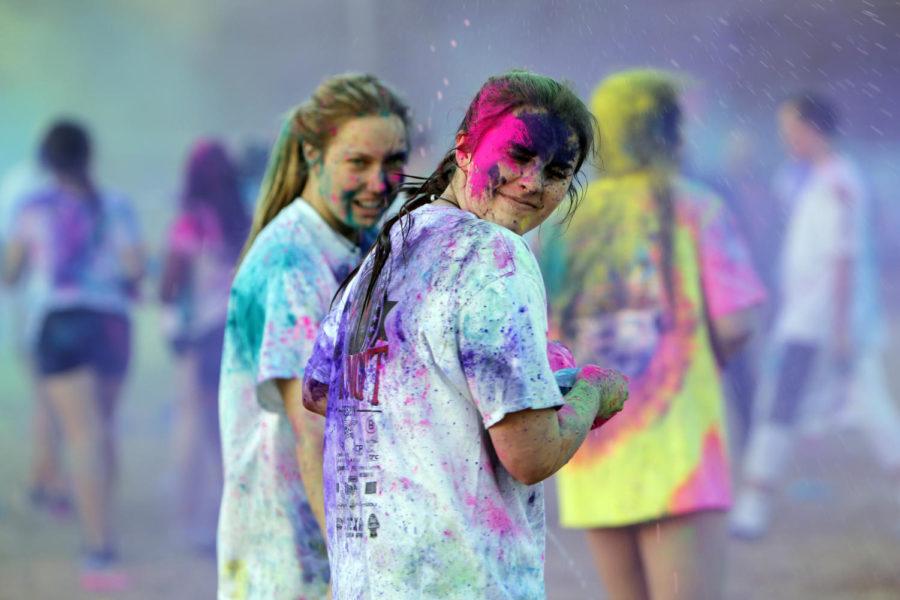 Kaylee Murray, 11, is hit in her face with powder by junior Courtney Taylor.  Color Clash is the first event of the week. (Yibran Franco photo)