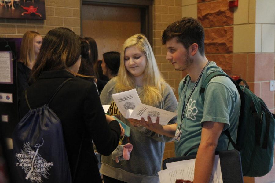 Senior Joseph Castronovo and sophomore Kaitlyn Pasierb discuss the AP English III presentations after the event.