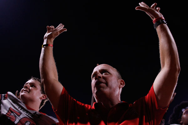 Head Coach, Chris Melson holds up the "L-side" hand signal during varsity football's match against Lancaster on Sept. 29. 