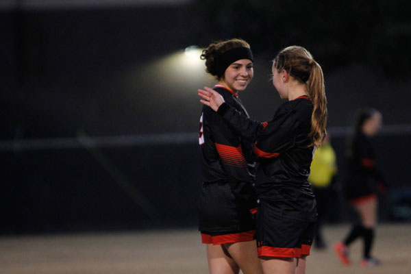 Wendy Cantu, 12, speaks with her teammate during the Broncos match against Ducanville on Jan. 18. 