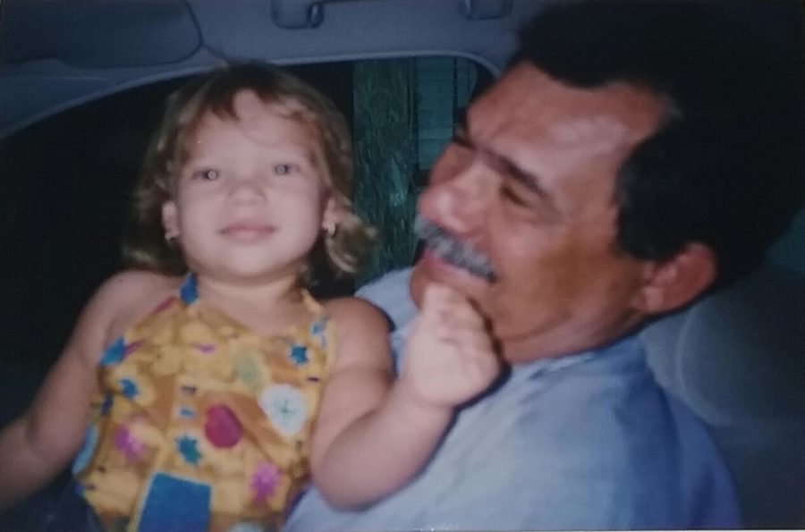 Senior Victoria Rodriguez and her grandfather posing for a photo before she moved to Florida.
