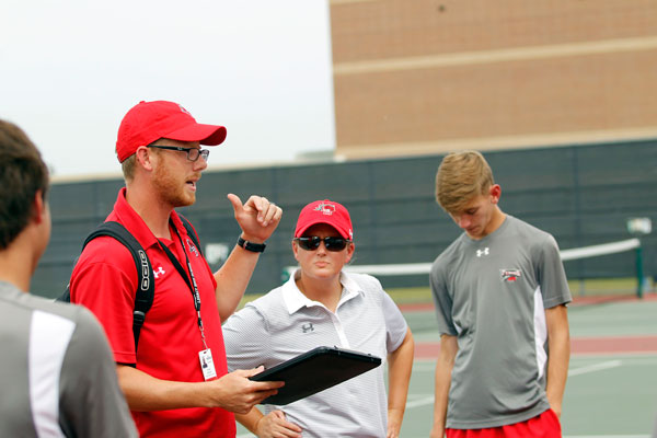 Coach Chad Dozier talks to his athletes on their Sept. 12 match. 