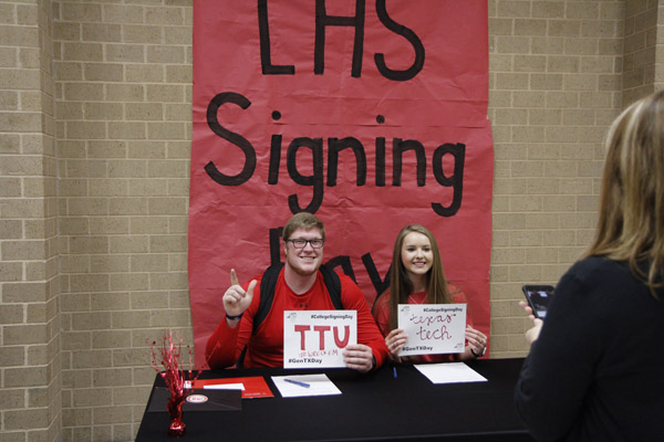 Alumni Clayton Franks and Karlee Kroner participate in the College Signing Day in 2018. The event included cake and a photo booth to celebrate all seniors going to college.