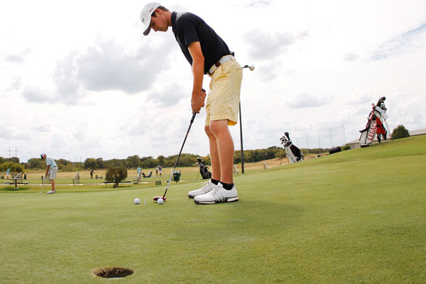 Jackson Powers, 11, practices his short game