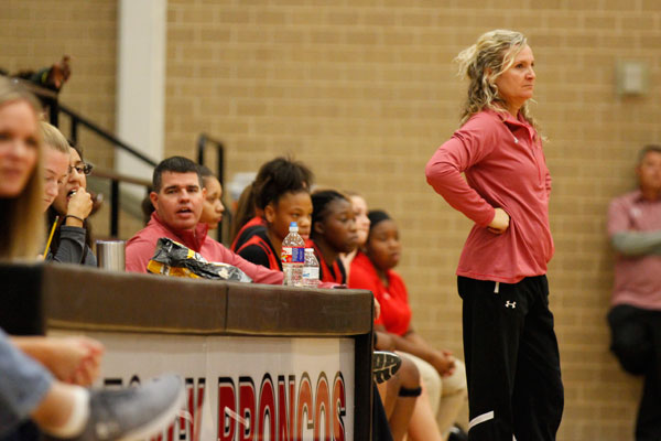 Girls Basketball Coach Michelle Morris watches her team compete in a game