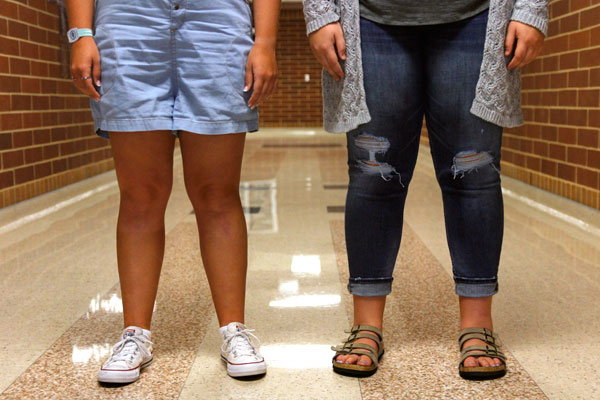 Junior Brooke Johnson and sophomore Jordyn Folsom wear shorts and ripped jeans now allowed by new dress code. 