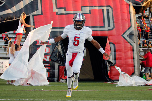 Jalen Catalon, 12, runs through the Bronco tunnel to excite the crowd before the beginning of the Jenks Border Brawl game in Oklahoma. (Kristen Bosecker photo)