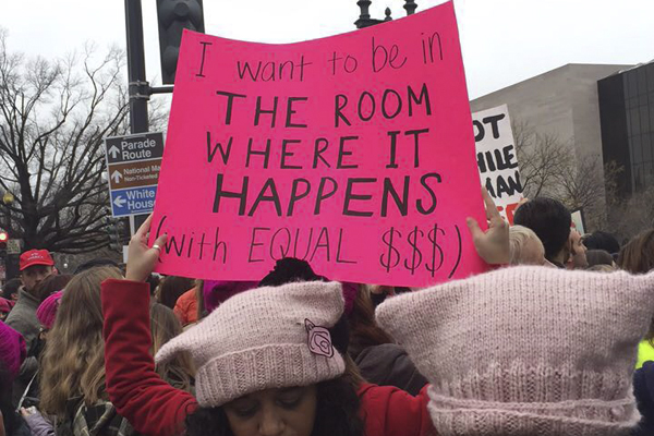 Womens March protester holds up sign with quote from Broadway musical Hamilton.