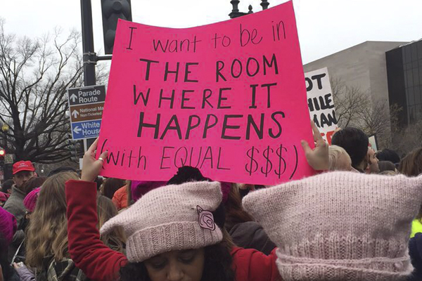 Women's March protester holds up sign with quote from Broadway musical Hamilton.