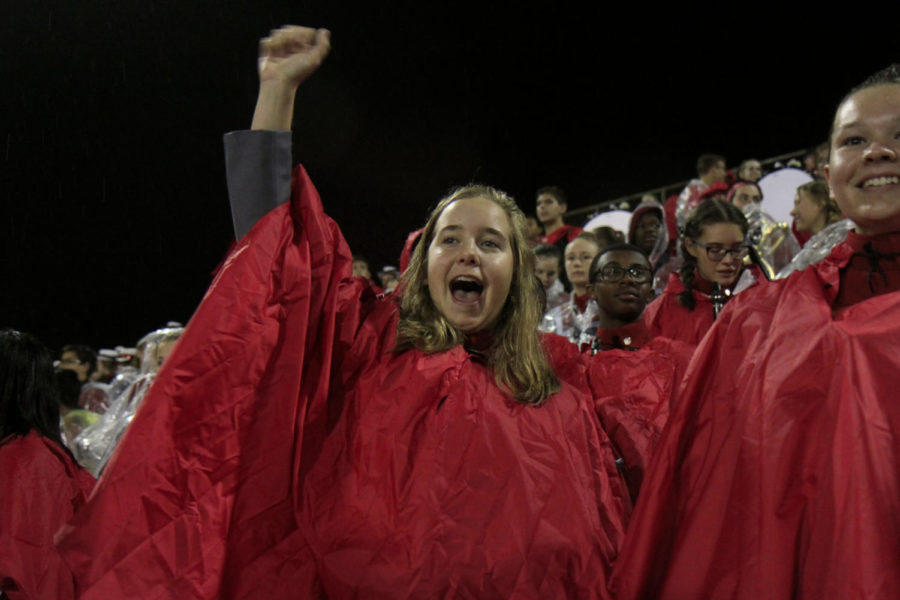 Wearing a poncho, Sydney Shannon, 10, cheers with the band for the Legacy football team in the stands. Band was unable to preform because of rain. Legacy beat Woodrow Wilson 42-6 on Oct. 19.