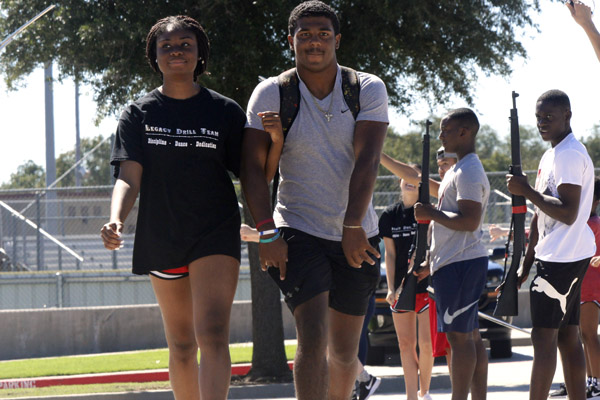 Ayo Abiara, 12, and Jalen Catalon, 12, rehearse for the homecoming festivities on Oct. 9 on the band practice field. Homecoming king and queen will be announced during halftime at the game on Oct. 12.