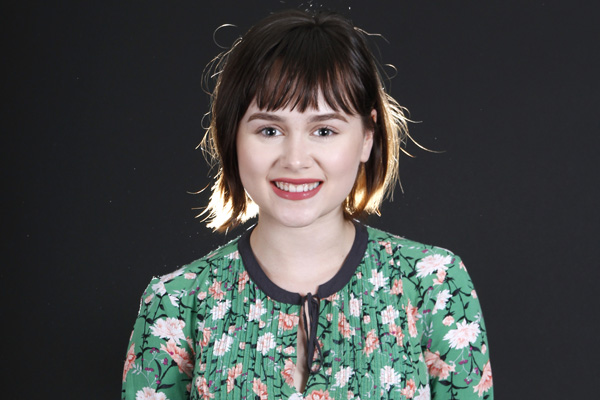 Natalie Pixler, 12, poses in the journalism studio for a picture.