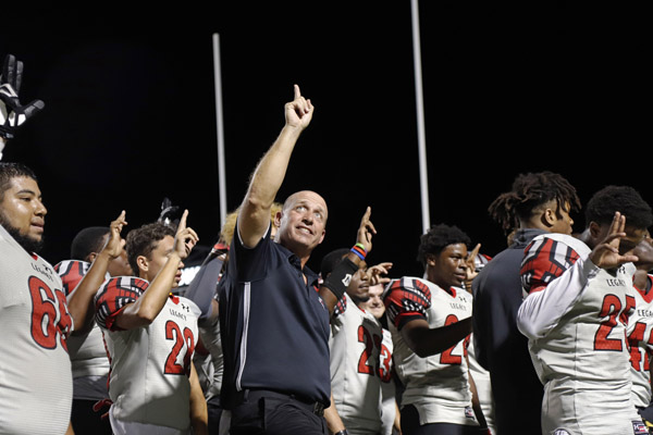 Coach Chris Melson celebrates after a win against Timberview on Sept. 28. Legacy won against Timberview, 27-22. (Seth Miller photo)