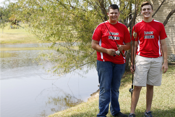 Austin Vanzant and Logan Tayor, 12, pose for a picture during Fishing Club.