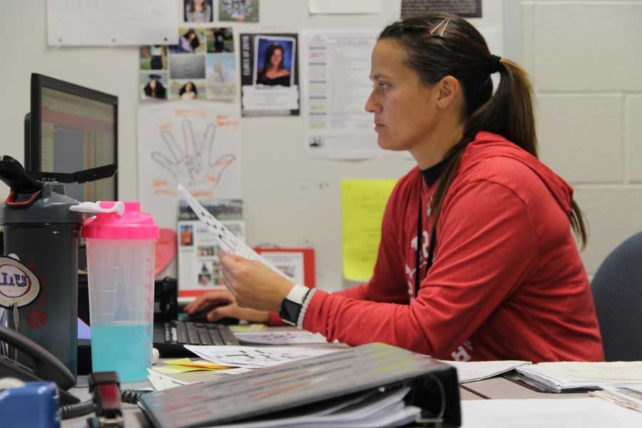 Coach Lacy Beckler works at her desk during her off period. Beckler works a second job to earn extra money. 
