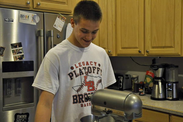 Landry Parlin, 10, bakes the dough for cinnamon rolls. Parlin sells the rolls to friends and family during the holidays for spending money. 