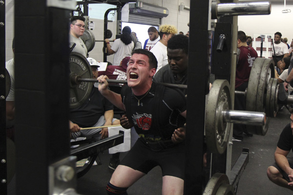 Clay Robinson, 12, squats during powerlifting. 