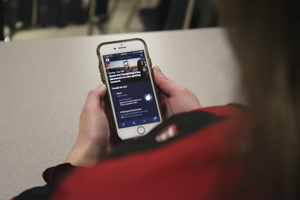 Kristen Bosecker, 12, looks at Twitter on her phone during class. 