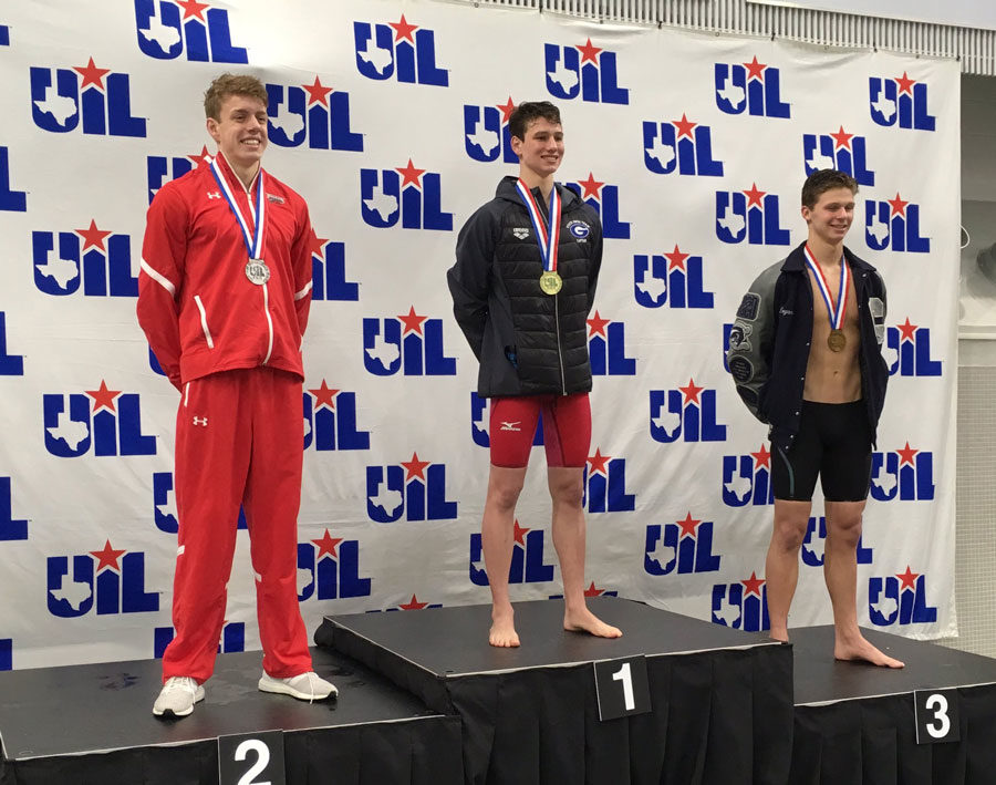 Eric Stelmar, 11, on the podium after coming second in the 100m backstroke at the state meet.