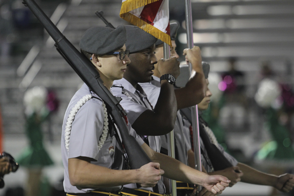 Carson Keeley and Soloman Davis, 12, present the colors at the football game against Bryan Adams