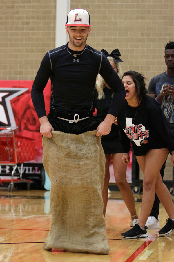 Payton Cathey, 12, represents the seniors in the sack races at the Battle of the Classes pep rally on Feb. 1. (Ellie Brutsche photo)