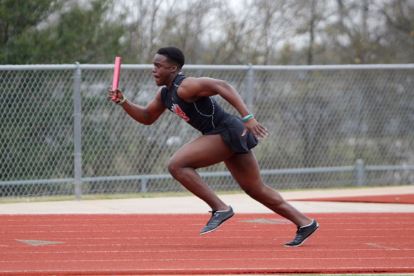 Ayo Adeyi, 11, runs in the JV boys 4 x 200 m relay race. (Ellie Brutsche photo)