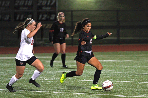 Ashely Perez, 12, dribbles the ball past a defender in her game against Burleson.