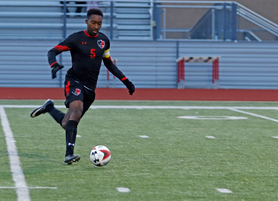 Bryan Ukeje, 12, dribbles the soccer ball down the field against Burleson.