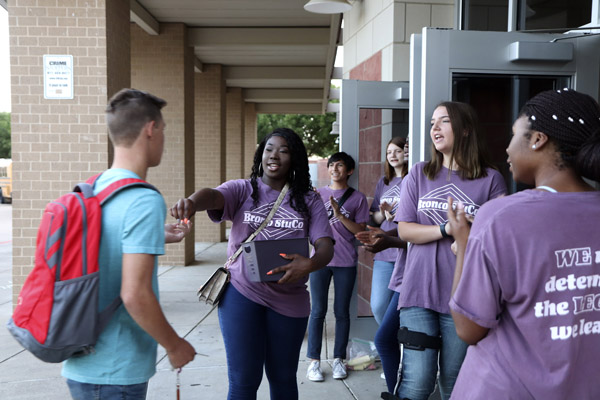 Student Council members hold open the cafeteria door for people to enter the building on August 14.