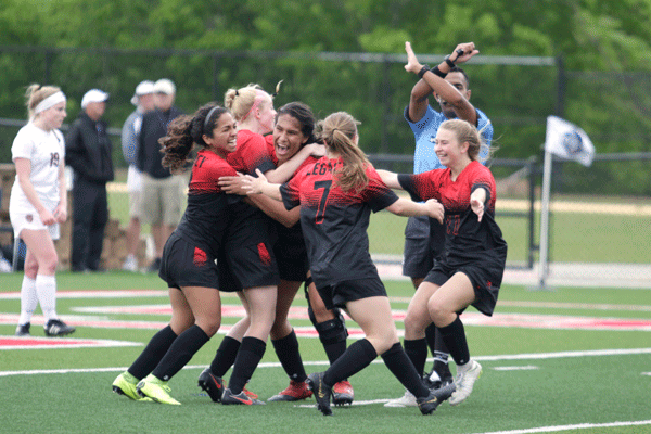 The girls soccer team celebrates after Andrea Garcia, 11, scores a goal in the first half. (Ellie Brutsche photo)
