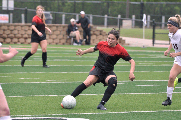 Lilee Simpson, 11, kicks the ball to get it away from a Dripping Springs player. (Landry Pedroza photo)