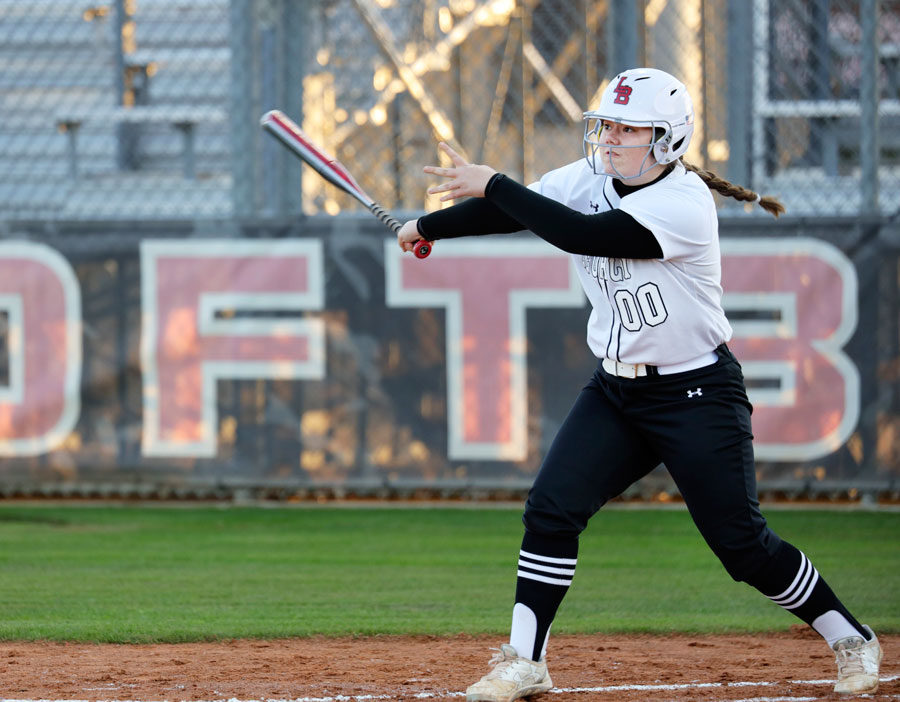 Katie Shoemaker, 12, hits the softball in their game against Centennial