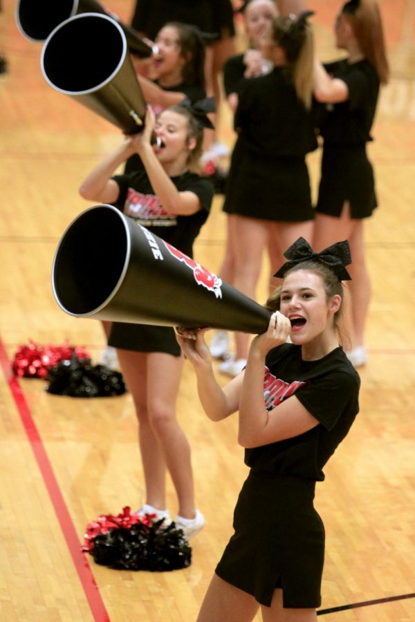 Jv cheerleader Autumn Hurta, 9, yells cheers into the megaphone to hype up the crowd during the pep rally. (Megan Novak photo)